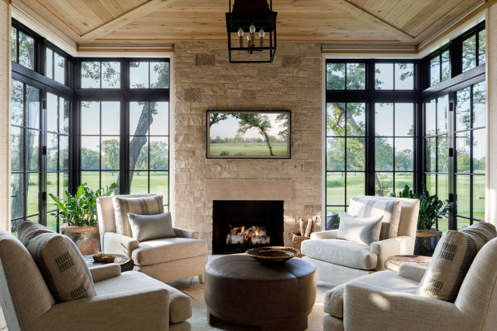 Example of a large classic travertine floor and beige floor sunroom design in Chicago with a standard fireplace, a stone fireplace and a standard ceiling