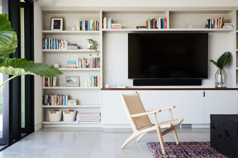 Family room - contemporary open concept gray floor family room idea in Los Angeles with white walls and a media wall