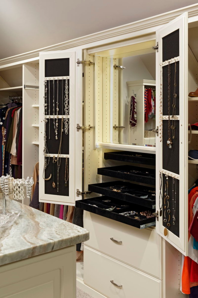 Design ideas for a large traditional women's dressing room in DC Metro with raised-panel cabinets and carpet.