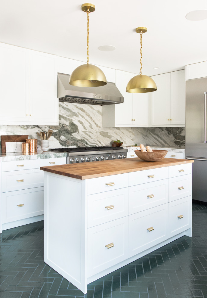 This is an example of a large contemporary l-shaped separate kitchen in Los Angeles with recessed-panel cabinets, white cabinets, marble benchtops, multi-coloured splashback, marble splashback, stainless steel appliances, brick floors, with island, green floor and green benchtop.