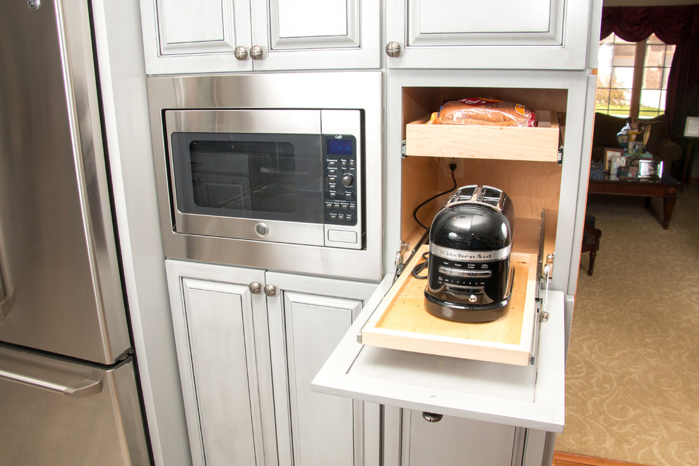 Eat-in kitchen - large transitional u-shaped porcelain tile and beige floor eat-in kitchen idea in Milwaukee with an undermount sink, raised-panel cabinets, gray cabinets, granite countertops, white backsplash, marble backsplash, stainless steel appliances and no island