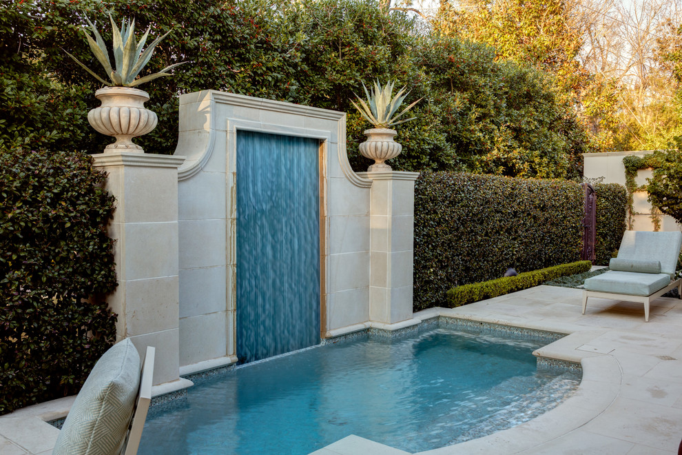Photo of a transitional backyard custom-shaped pool in Houston with a hot tub and natural stone pavers.