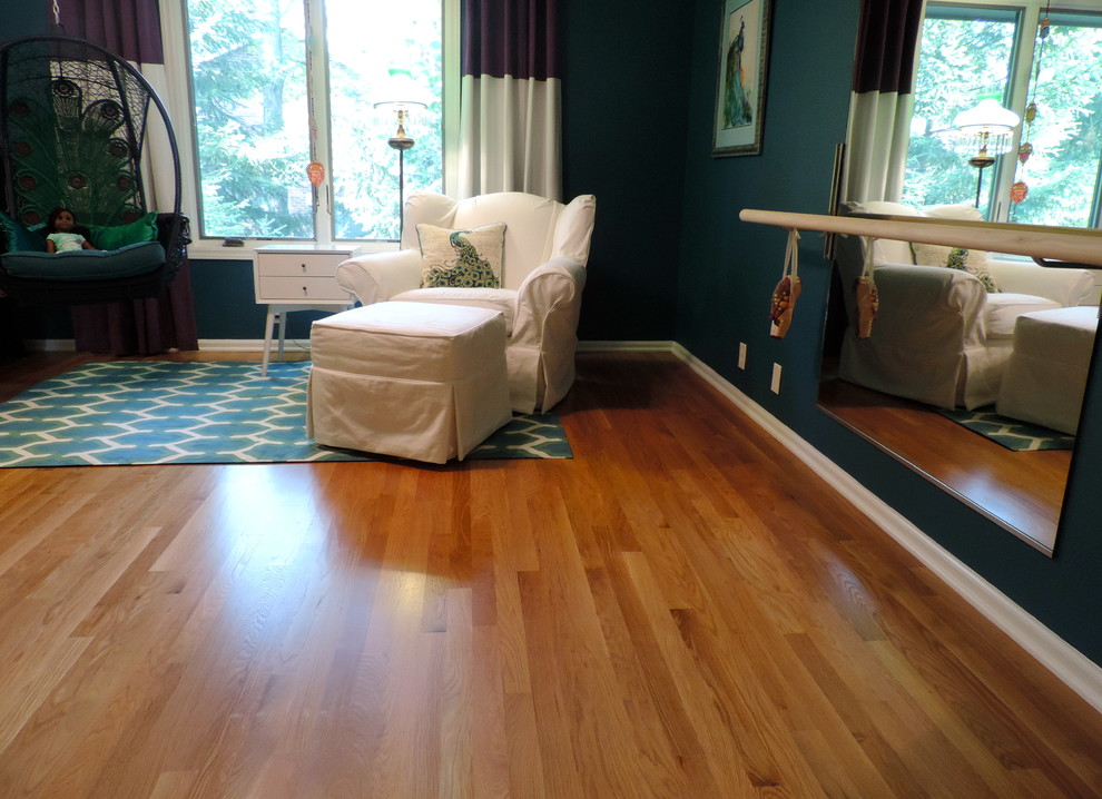 Design ideas for a mid-sized eclectic kids' room for girls in Indianapolis with blue walls and medium hardwood floors.