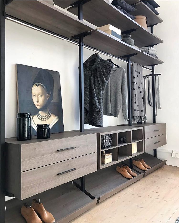 Inspiration for a large modern gender-neutral dressing room in Boston with open cabinets, brown cabinets, light hardwood floors and beige floor.