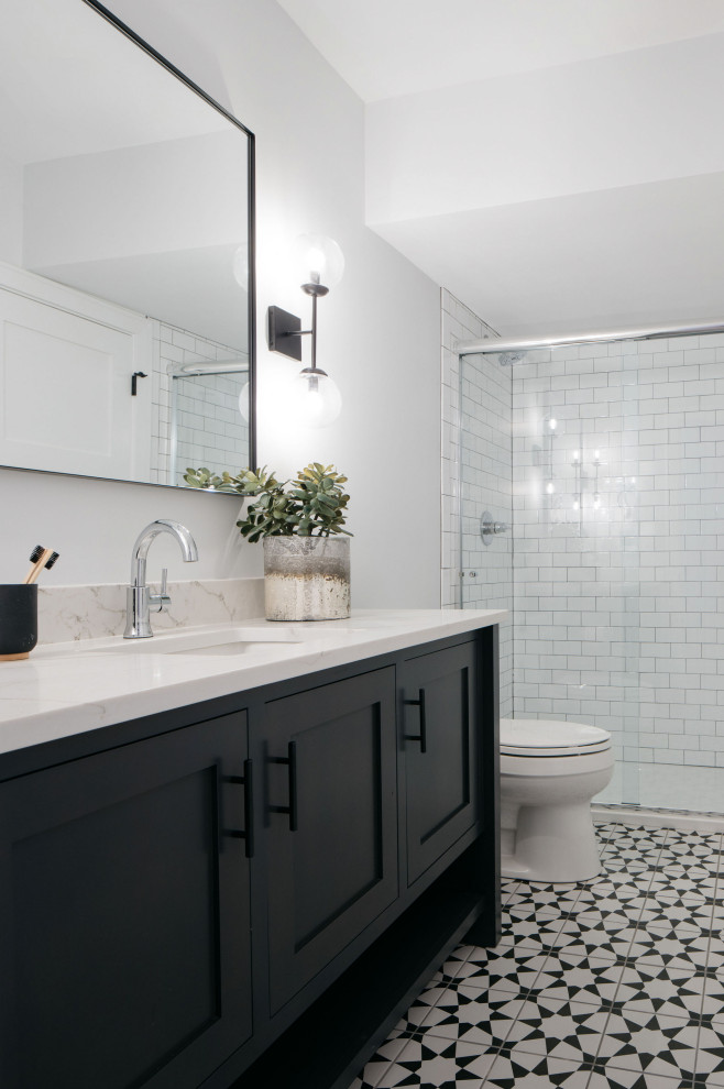 Inspiration for a country 3/4 bathroom in Chicago with shaker cabinets, black cabinets, grey walls, an undermount sink, multi-coloured floor, a sliding shower screen, white benchtops, a single vanity and a built-in vanity.