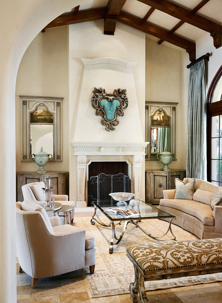 This is an example of a large mediterranean open concept living room in Phoenix with a stone fireplace surround, beige walls, travertine floors, a standard fireplace and no tv.