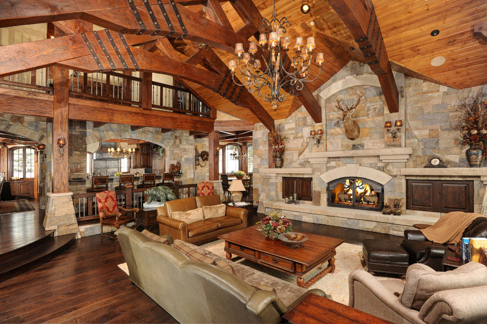 Inspiration for a country formal open concept living room in Denver with dark hardwood floors, a standard fireplace, a stone fireplace surround and no tv.