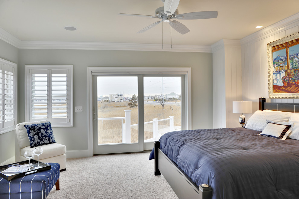 Beach style bedroom in Other with grey walls and carpet.