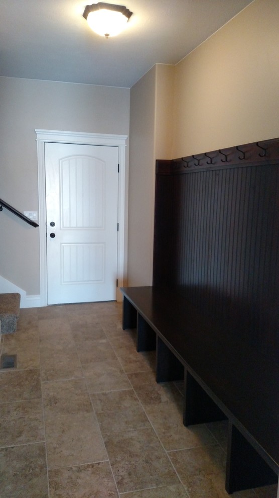 Mudroom - large transitional ceramic tile mudroom idea with beige walls