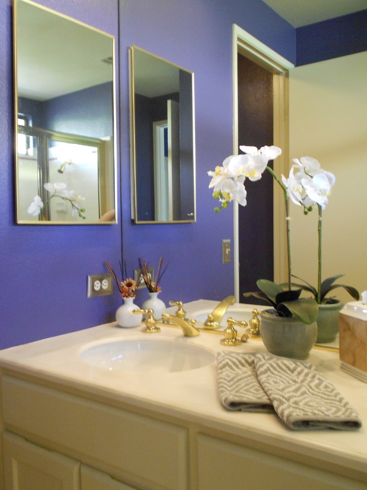 Mid-sized eclectic master bathroom in Los Angeles with recessed-panel cabinets, white cabinets, a corner shower, purple walls, an undermount sink, an alcove tub, a one-piece toilet, white tile, ceramic tile and solid surface benchtops.