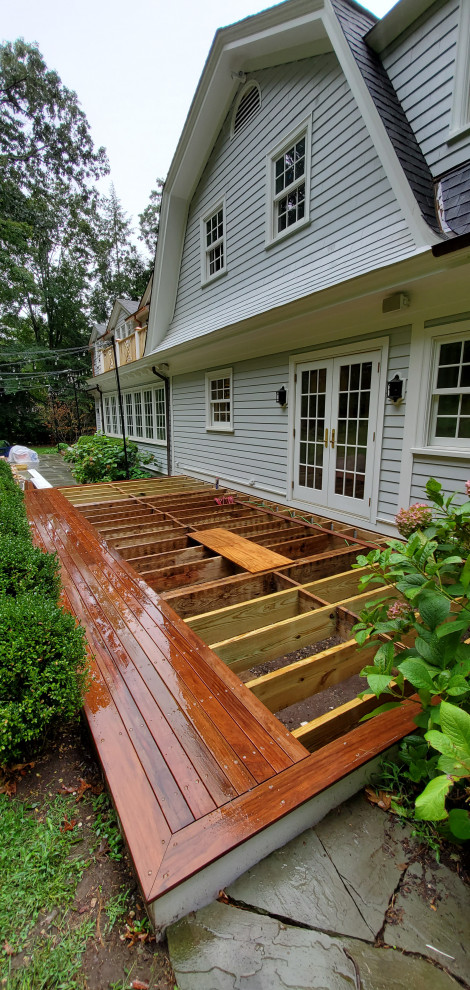 This is an example of a mid-sized contemporary backyard deck in New York.