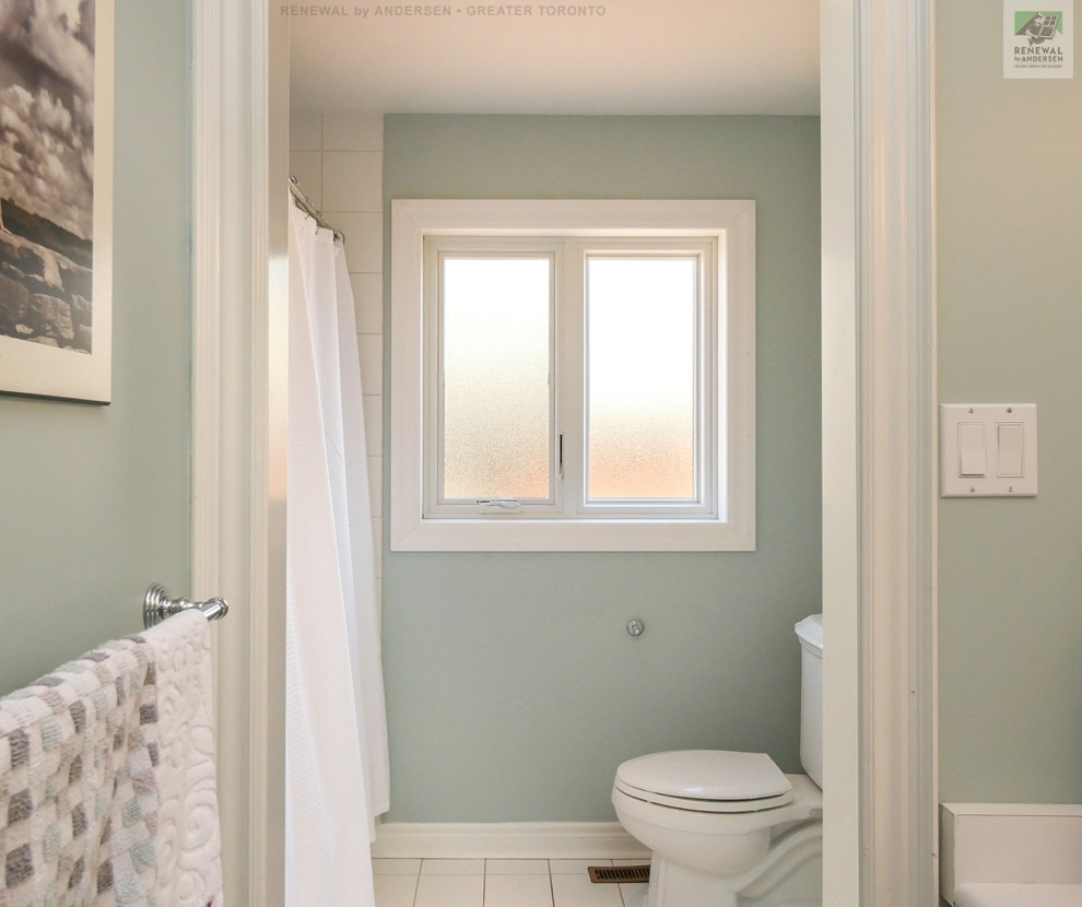 This is an example of a large ensuite bathroom in Toronto with white cabinets, an alcove bath, a shower/bath combination, a two-piece toilet, white tiles, ceramic tiles, green walls, ceramic flooring, an integrated sink, laminate worktops, white floors, a shower curtain, white worktops, an enclosed toilet, double sinks and a built in vanity unit.