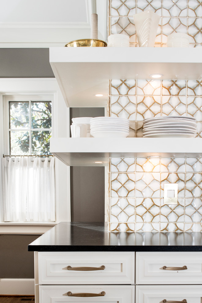 Large transitional u-shaped medium tone wood floor and brown floor eat-in kitchen photo with a farmhouse sink, white backsplash, glass tile backsplash, stainless steel appliances, an island, recessed-panel cabinets, white cabinets and marble countertops