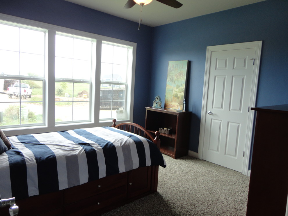 Large traditional guest bedroom in Milwaukee with blue walls and carpet.
