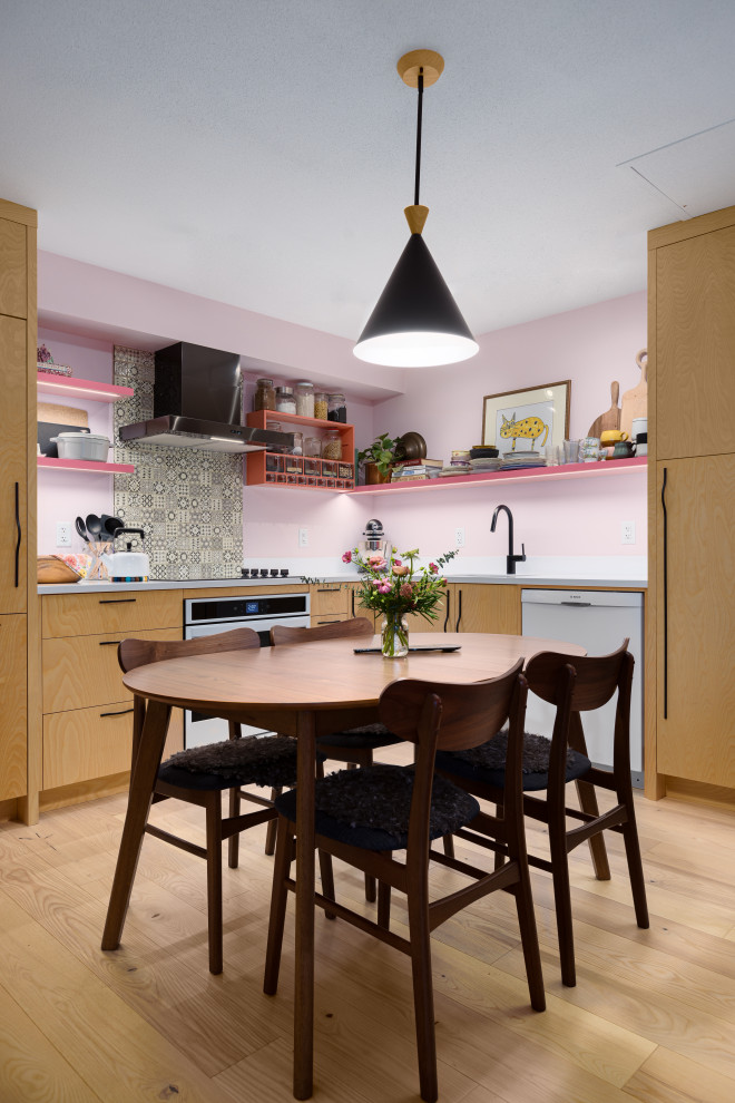 This is an example of a small scandinavian l-shaped open plan kitchen in Vancouver with a single-bowl sink, flat-panel cabinets, yellow cabinets, quartz benchtops, white splashback, subway tile splashback, white appliances, light hardwood floors, no island, beige floor and white benchtop.