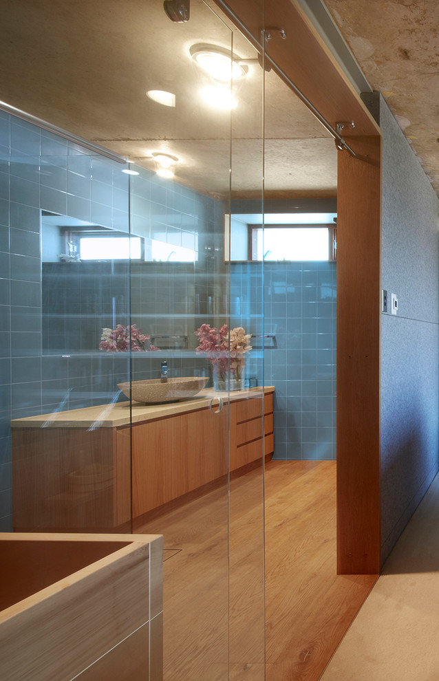 This is an example of an asian bathroom in Sydney with light hardwood floors.