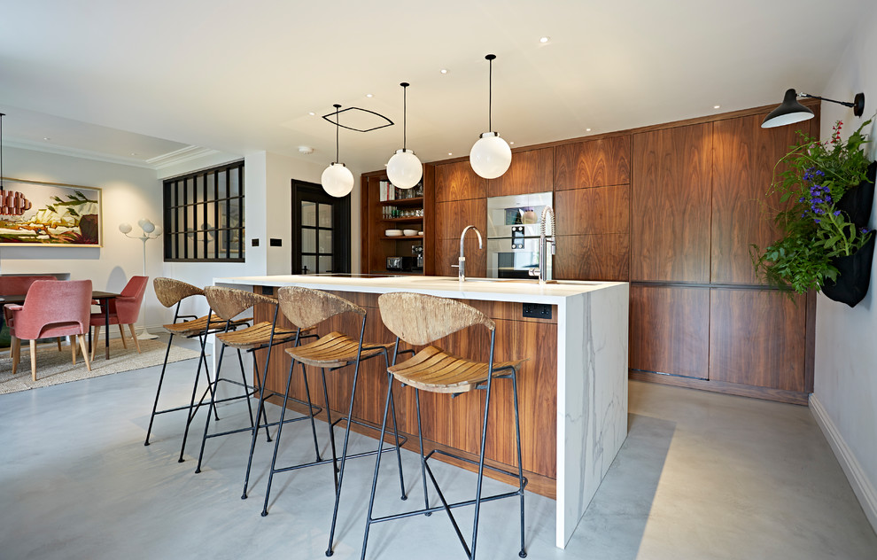 Design ideas for a mid-sized midcentury single-wall open plan kitchen in Devon with flat-panel cabinets, dark wood cabinets, marble benchtops, panelled appliances, concrete floors, a peninsula and grey floor.