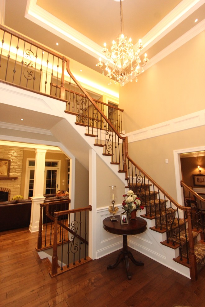 Example of a transitional medium tone wood floor foyer design with beige walls