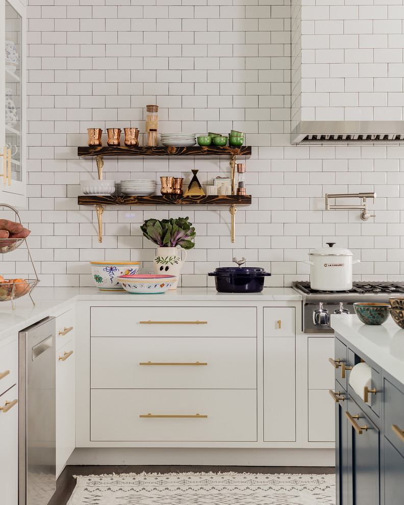 Inspiration for a large transitional l-shaped eat-in kitchen in New York with an undermount sink, flat-panel cabinets, white cabinets, quartz benchtops, white splashback, subway tile splashback, stainless steel appliances, medium hardwood floors, with island and brown floor.