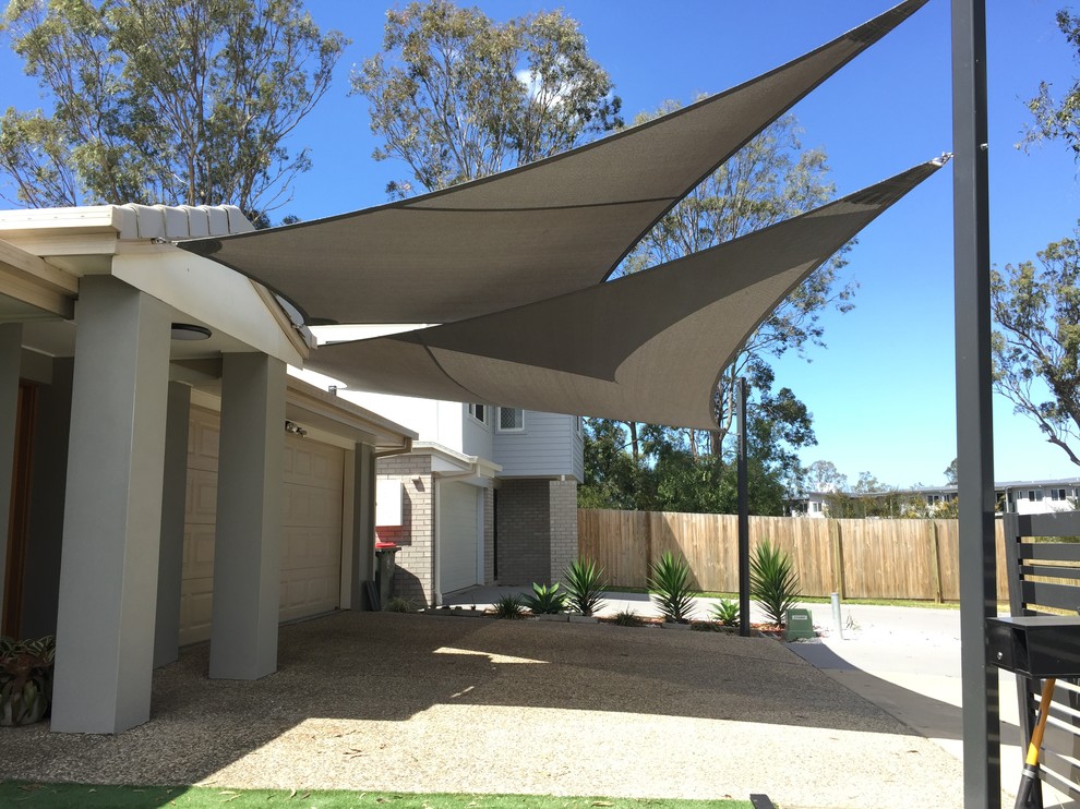 Inspiration for an expansive modern attached two-car carport in Brisbane.