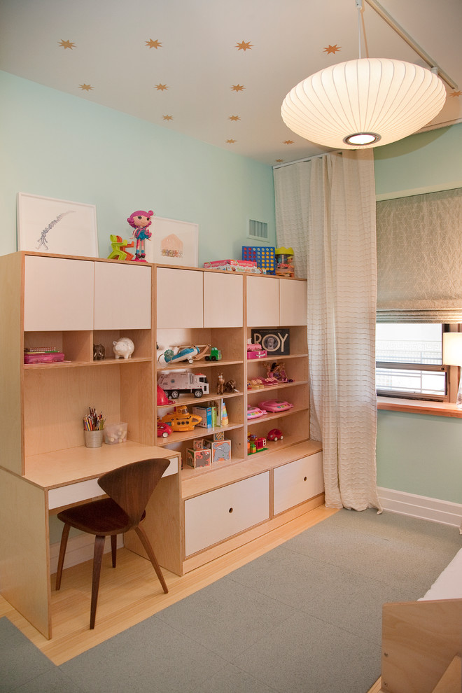This is an example of a contemporary gender-neutral kids' study room for kids 4-10 years old in New York with blue walls and light hardwood floors.