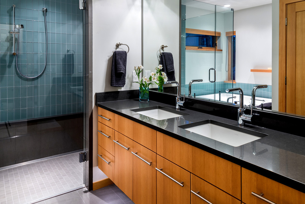 This is an example of a mid-sized contemporary master wet room bathroom in Other with flat-panel cabinets, medium wood cabinets, blue tile, glass tile, porcelain floors, an undermount sink and engineered quartz benchtops.