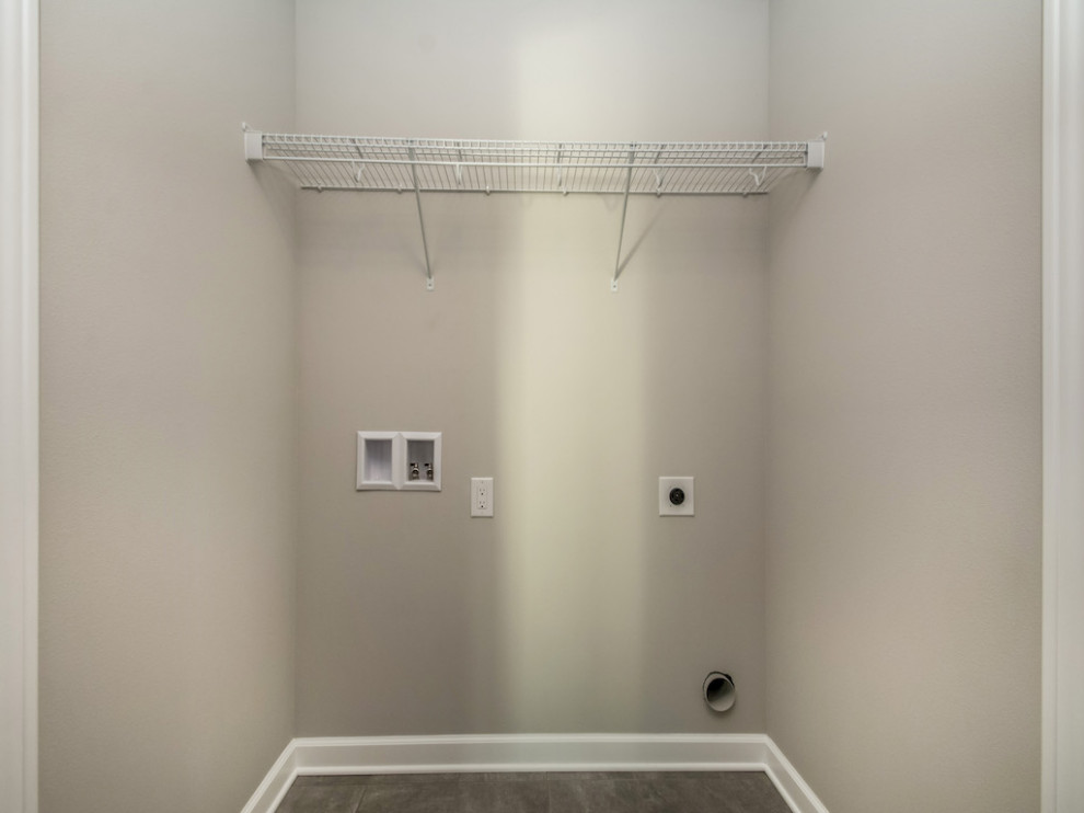 Dedicated laundry room - small transitional single-wall ceramic tile and gray floor dedicated laundry room idea with beige walls and a side-by-side washer/dryer