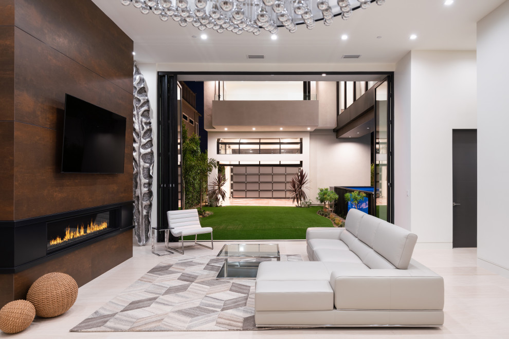 This is an example of a large contemporary open concept living room in San Diego with white walls, a standard fireplace, a built-in media wall and beige floor.