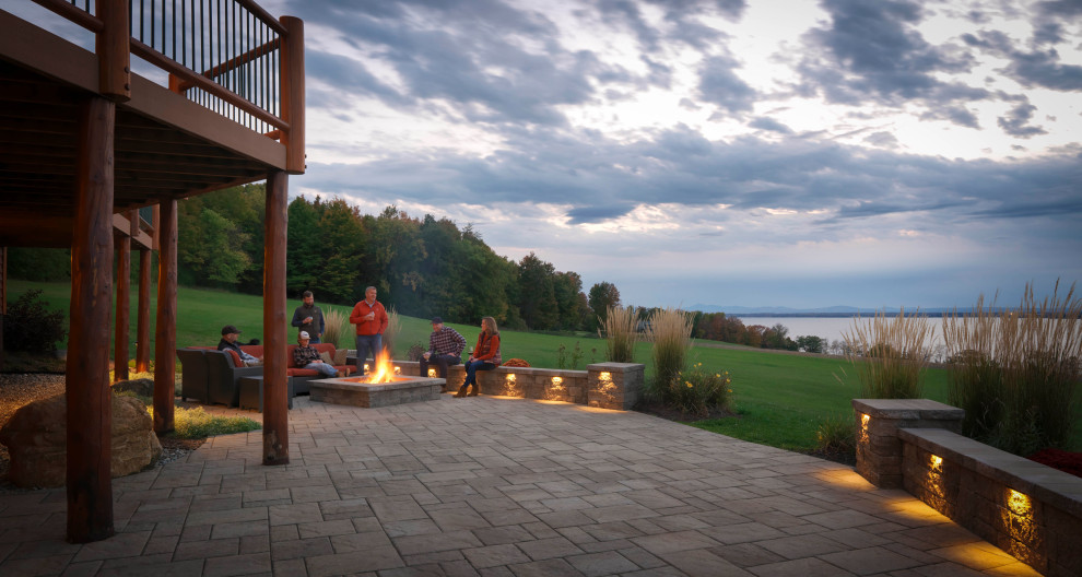 Photo of an expansive country backyard full sun garden in Burlington with a fire feature and concrete pavers.
