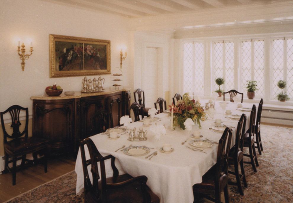 Inspiration for a large traditional separate dining room in Philadelphia with beige walls, medium hardwood floors, a standard fireplace and a tile fireplace surround.