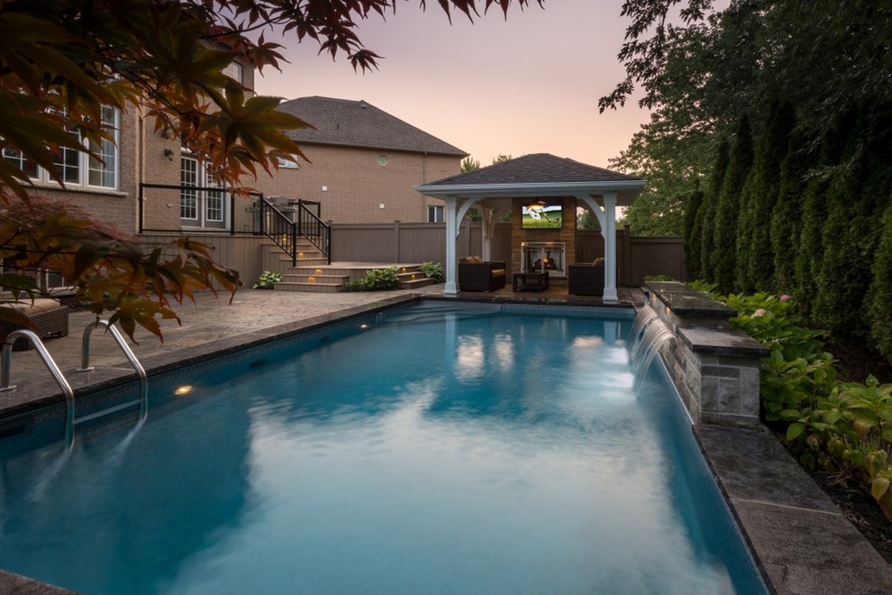Pool - transitional backyard pool idea in Toronto