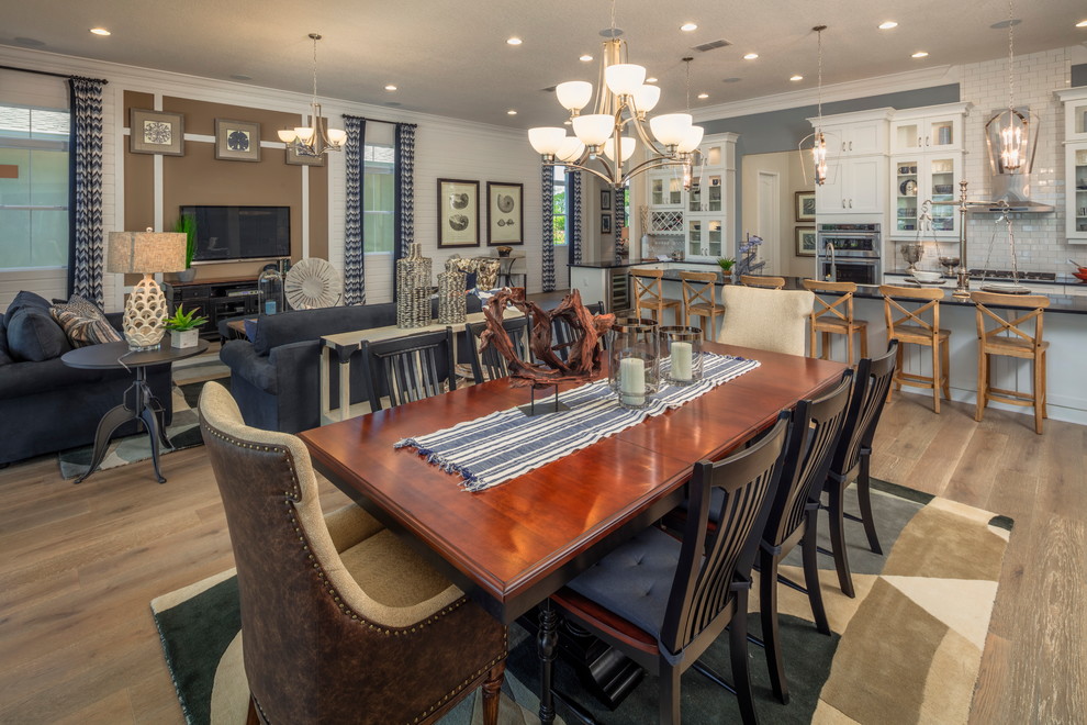 This is an example of a large arts and crafts kitchen/dining combo in Orlando with multi-coloured walls, medium hardwood floors, no fireplace and brown floor.