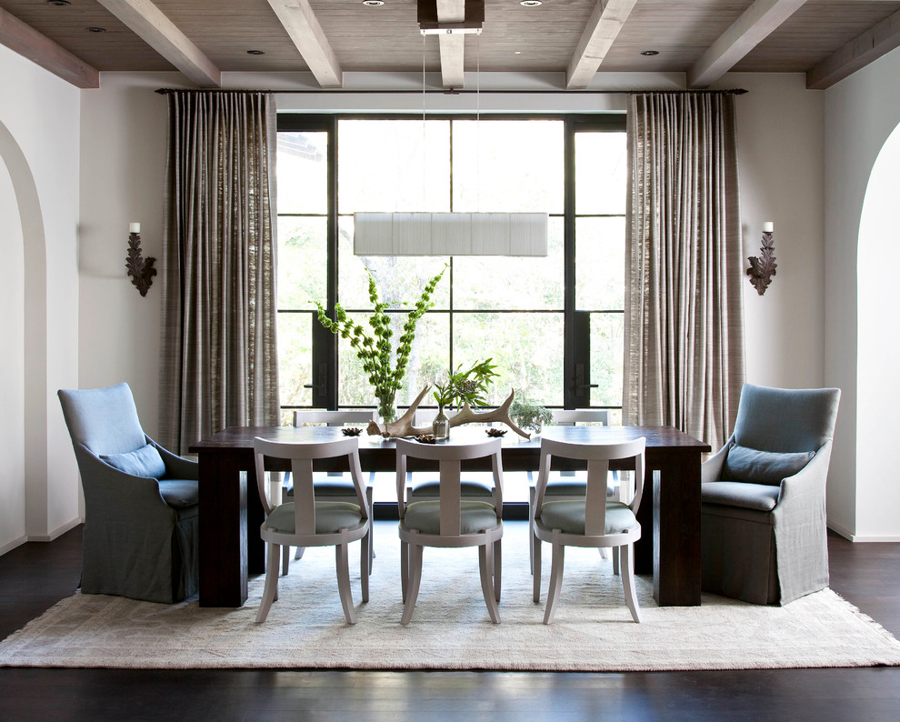 Mediterranean dining room in Austin with white walls and dark hardwood floors.