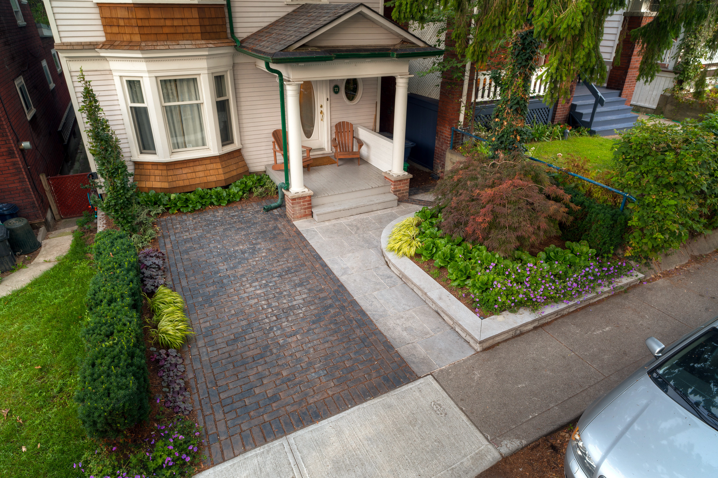 Inspiration for a small modern partial sun front yard brick driveway in Toronto for summer.