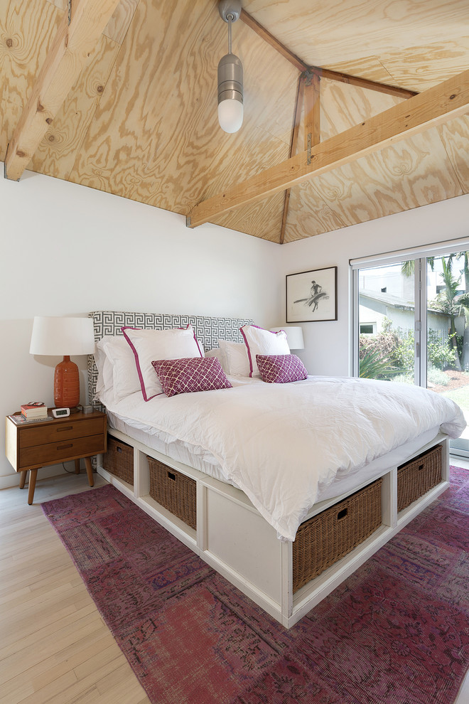 Trendy master light wood floor bedroom photo in Los Angeles with white walls
