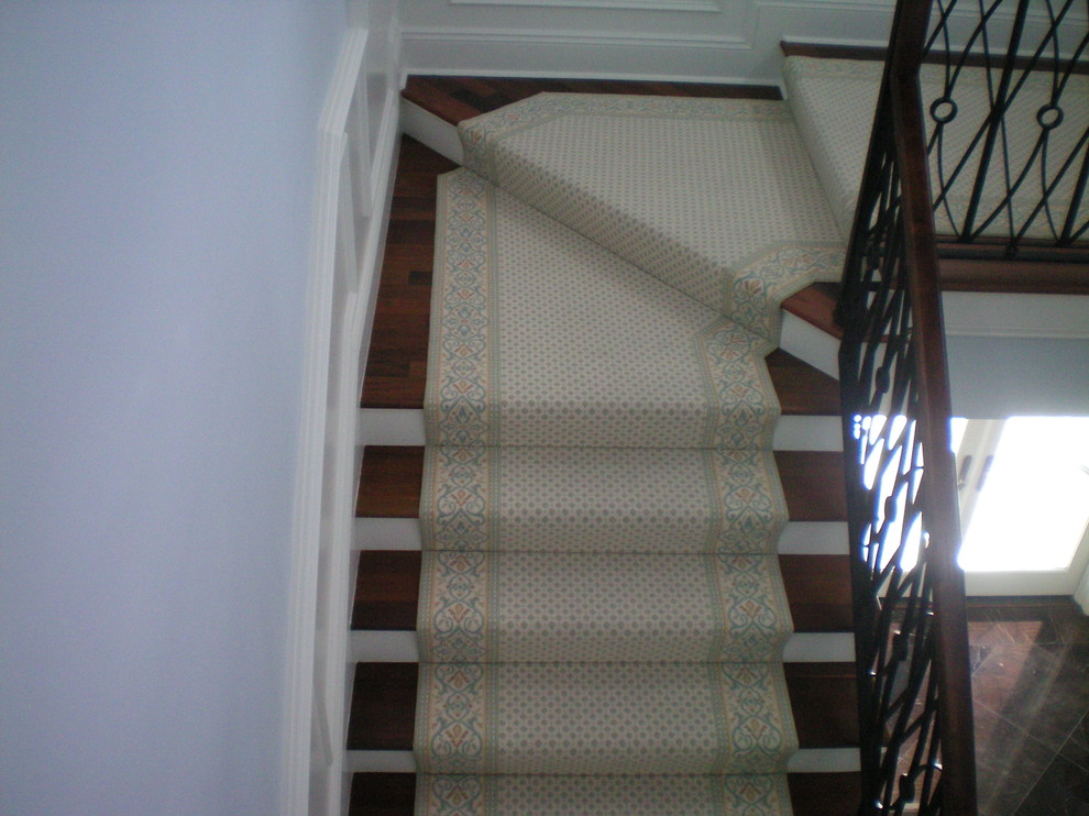 This is an example of a mid-sized traditional wood l-shaped staircase in Tampa with painted wood risers.