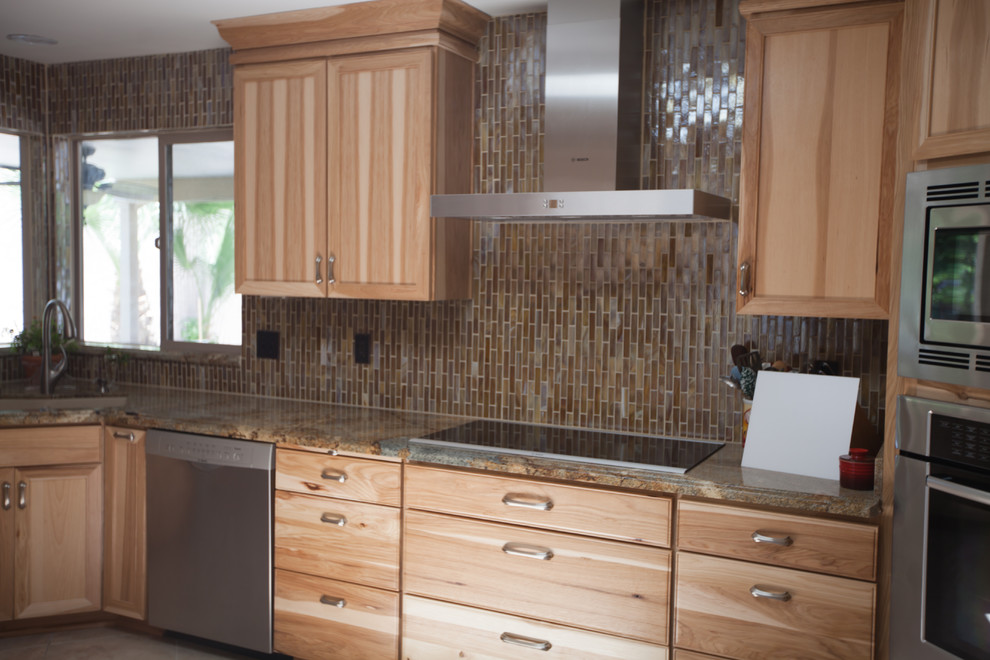 Inspiration for a large transitional galley ceramic tile enclosed kitchen remodel in Phoenix with an undermount sink, recessed-panel cabinets, light wood cabinets, granite countertops, brown backsplash, glass tile backsplash and stainless steel appliances
