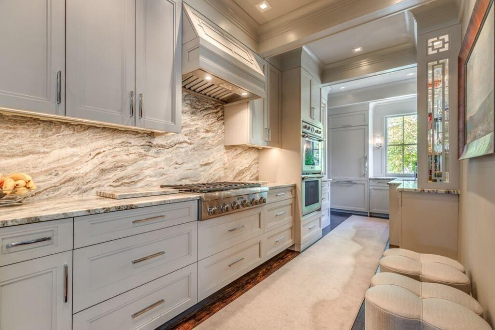 Kitchen - large transitional u-shaped medium tone wood floor and brown floor kitchen idea in Boston with an undermount sink, shaker cabinets, white cabinets, marble countertops, gray backsplash, marble backsplash, stainless steel appliances, an island and gray countertops