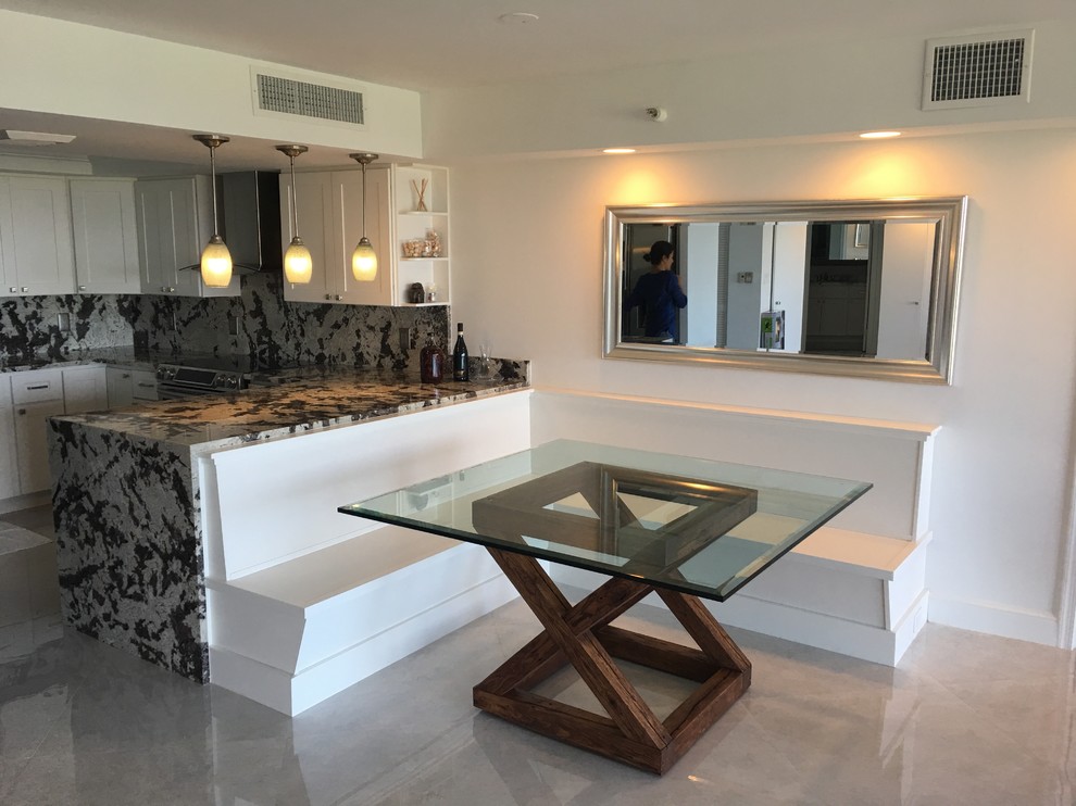 Mid-sized contemporary l-shaped eat-in kitchen in Miami with a single-bowl sink, shaker cabinets, white cabinets, marble benchtops, grey splashback, stainless steel appliances, marble floors and a peninsula.