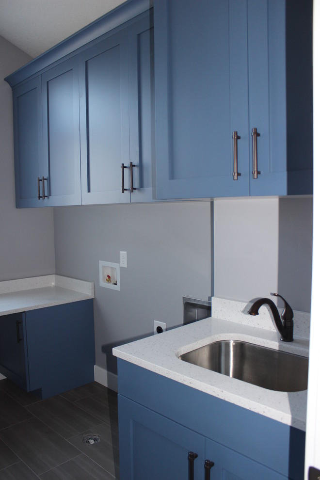 Large arts and crafts u-shaped utility room in Salt Lake City with an undermount sink, raised-panel cabinets, grey cabinets, granite benchtops, grey walls, ceramic floors and a side-by-side washer and dryer.