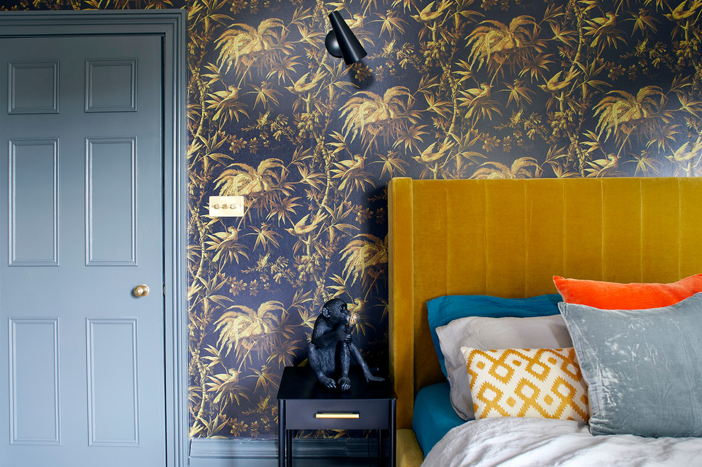 This is an example of a mid-sized eclectic guest bedroom in London with grey walls.