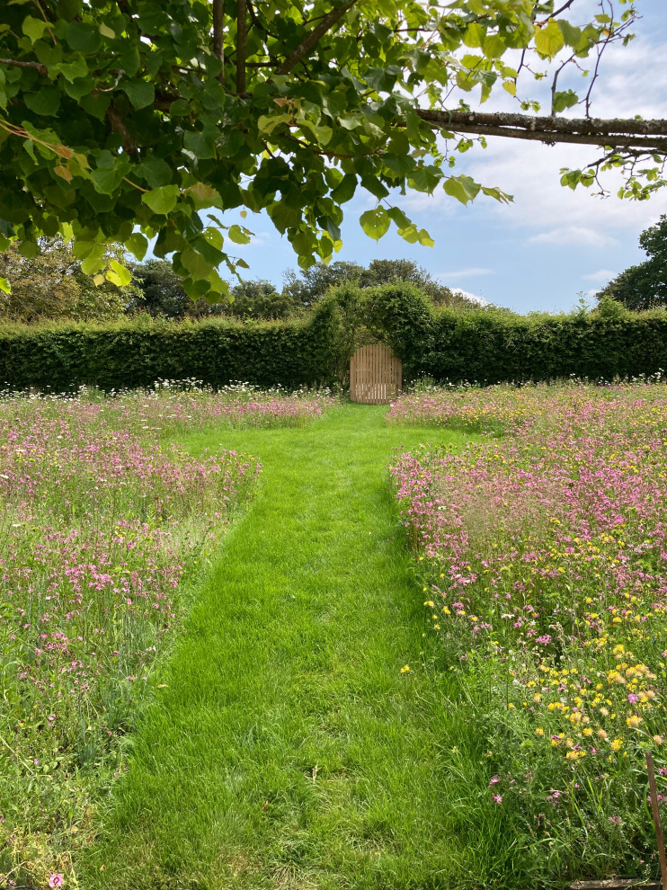 Design ideas for a huge traditional full sun backyard landscaping in Dorset.