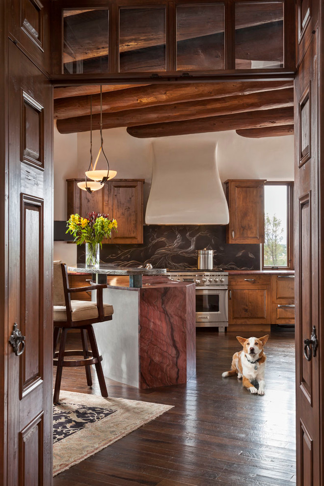Inspiration for a mid-sized country kitchen in Orange County with raised-panel cabinets, dark wood cabinets, stainless steel appliances, with island and dark hardwood floors.