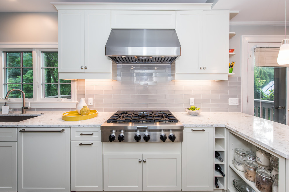 Mid-sized contemporary galley eat-in kitchen in DC Metro with an undermount sink, recessed-panel cabinets, white cabinets, quartz benchtops, grey splashback, subway tile splashback, stainless steel appliances, slate floors, a peninsula, multi-coloured floor and white benchtop.