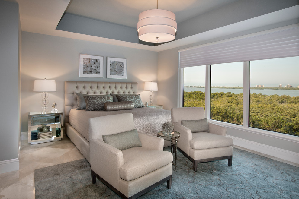 Inspiration for a large transitional master bedroom in Miami with grey walls and ceramic floors.