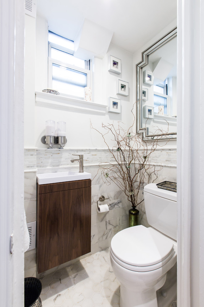 Design ideas for a transitional powder room in New York with a two-piece toilet, white tile, marble, white walls, marble floors, a wall-mount sink and white floor.