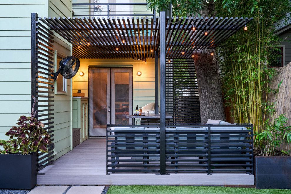 This is an example of a small contemporary backyard patio in Austin with a fire feature and a pergola.