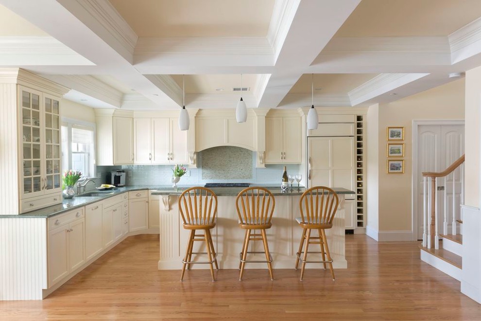 Inspiration for a traditional l-shaped kitchen in Boston with an undermount sink, shaker cabinets, beige cabinets, blue splashback, panelled appliances, medium hardwood floors and with island.