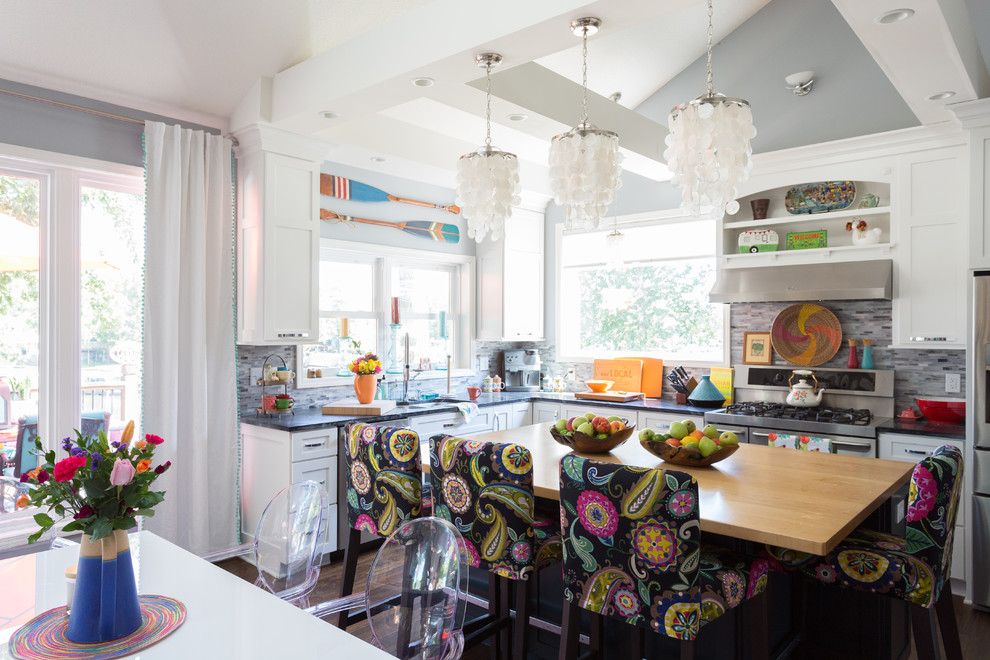 This is an example of an eclectic l-shaped kitchen in Kansas City with stainless steel appliances and with island.