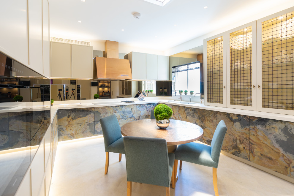 Inspiration for a contemporary u-shaped separate kitchen in London with a double-bowl sink, flat-panel cabinets, beige cabinets, mirror splashback, no island, white floor and white benchtop.